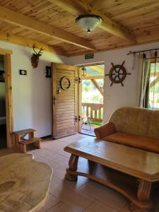 a living room with a couch and a table at Domki Białogarda in Wicko