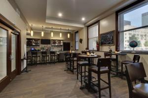 a restaurant with tables and chairs and a bar at Drury Plaza Hotel Cleveland Downtown in Cleveland