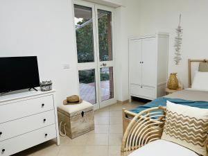 a bedroom with a bed and a tv on a dresser at Beach apartments Spiaggia Nascosta in Silvi Marina
