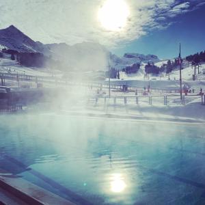 a hot spring with steam coming out of the water at PLAGNE BELLECOTE - 5 Pers - Vue Pistes - Acces Piscine chauffee in Plagne Bellecote