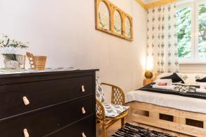 a bedroom with a black dresser and a bed at Sabałowe Bajania in Zakopane