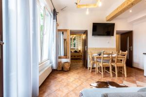 a kitchen and dining room with a table and chairs at Sabałowe Bajania in Zakopane