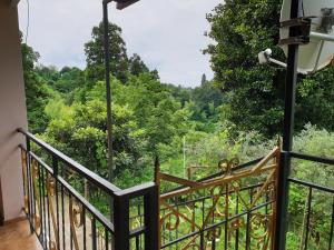 a balcony with a view of the forest at Green paradise in Batumi