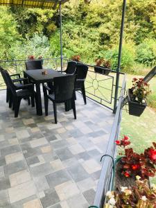a patio with a table and chairs and a fence at Holiday Home 108 in Bezdan