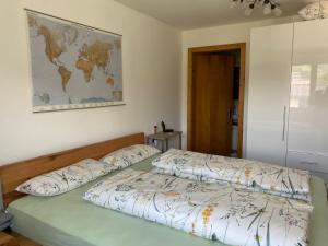 a bedroom with two beds and a map on the wall at Ferienwohnung Alpennestchen Tschagguns in Tschagguns