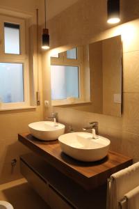 a bathroom with two sinks and a mirror at Albadorata in Praia a Mare