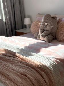 a stuffed elephant sitting on top of a bed at AHOY - Haus am Meer in Chłopy