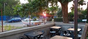 a row of tables and chairs next to a fountain at Albadorata in Praia a Mare