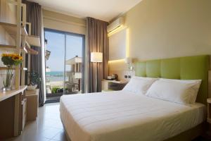 una camera con un grande letto e vista sull'oceano di Hotel Ostuni a Rimini