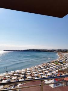 a view of a beach with umbrellas and the ocean at Hotel GAIA in Sozopol