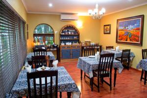 a restaurant with tables and chairs in a room at Four Seasons Guesthouses in Lephalale +38 photos