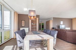 a dining room with a table and chairs at Hello Zeeland - Appartement Port Scaldis 15-042 in Breskens