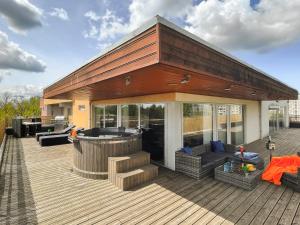 a large deck with a hot tub on a house at Skyhouse Riga Lux Penthouse & SPA in Rīga