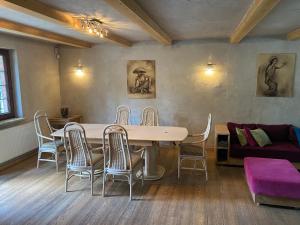 a dining room with a table and chairs and a couch at Willa pod Seidorfem in Sosnówka
