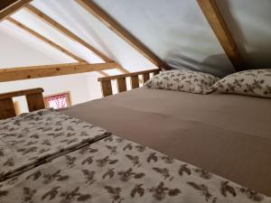 a bedroom with a bed in a attic at Holiday Home SAJRA in Kulen Vakuf