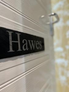 a sign on a door with the word hawes on it at Devonshire Arms Inn in Cracoe