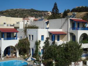 a view of a building with a swimming pool at Creta Sun Hotel Studios in Agia Pelagia