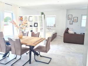 a living room with a dining room table and a bedroom at Penthaus in Soltau +10 photos