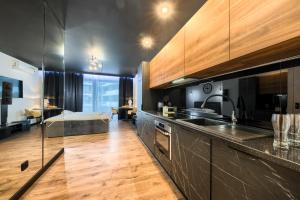 a kitchen with a sink and a counter top at Wola Luxury Stay in Warsaw