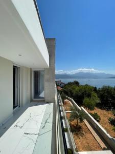 a balcony of a building with a view of the ocean at Villa Le Grand Bleu in Đenovići