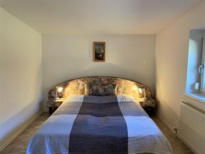 a bedroom with a large bed with lights on it at Holiday Home Anger - ANB100 by Interhome in Angerberg