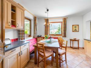 eine Küche und ein Esszimmer mit einem Tisch und Stühlen in der Unterkunft Holiday Home Haus am Sonnenhang by Interhome in Spielbichl