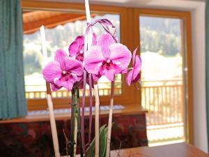 a group of pink flowers in a vase on a table at Apartment Erika by Interhome in Kappl +33 photos