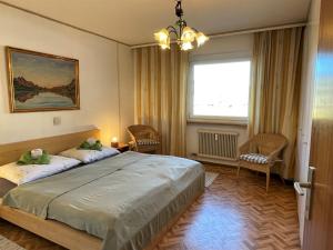 a bedroom with a large bed and a window at Apartment App- Sollereder by Interhome in Brixen im Thale