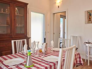 a dining room table with a red and white table cloth at Apartment Minú by Interhome in Porlezza