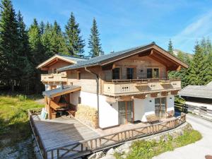 a log home with a deck and a house at Chalet Hochkrimml 2 by Interhome in Krimml