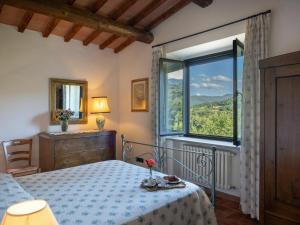 a bedroom with a bed and a large window at Holiday Home La Badia by Interhome in Dicomano