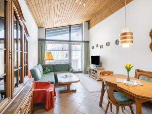 a living room with a couch and a table at Apartment Haus Point by Interhome in Maishofen