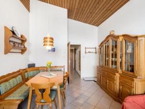 a living room with a table and a couch at Apartment Haus Point by Interhome in Maishofen