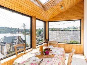 a dining room with a table and views of the water at Holiday Home Ti an Aod by Interhome in Plougasnou +18 photos