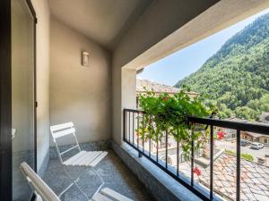 a balcony with chairs and a view of a mountain at Apartment Universo-4 by Interhome in Pré-Saint-Didier