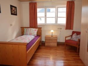 a small bedroom with a bed and a window at Holiday Home Roth by Interhome in Neuried