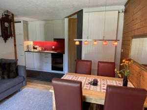 a kitchen and dining room with a table and chairs at Apartment Sweda by Interhome in Fieschertal