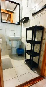 a bathroom with a sink and a mirror at Ośrodek Edward in Mikoszewo