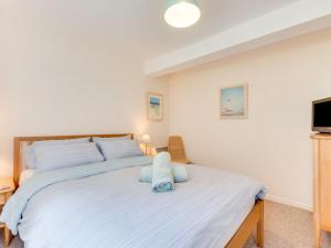 a bedroom with a large bed and a tv at Apartment Flat 11 Clifton Court by Interhome in Croyde