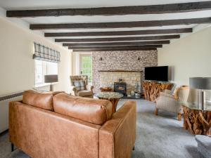 a living room with a couch and a fireplace at Holiday Home Burn Side by Interhome in Brackla