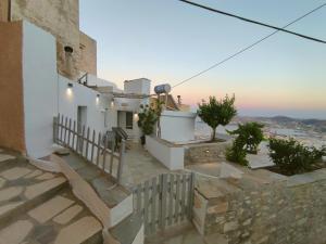 a house with a balcony with a view of the ocean at Rosolio in Ano Syros