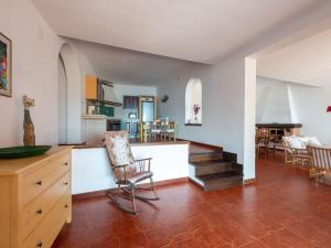 een keuken en een woonkamer met een tafel en stoelen bij Holiday Home Sole by Interhome in Porto Santo Stefano