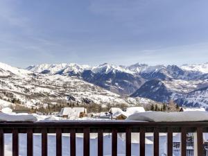 a view of snow covered mountains from a balcony at Apartment Les Alpages du Corbier-7 by Interhome in Le Corbier