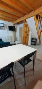 a large white table and chairs in a room at Ośrodek Edward in Mikoszewo