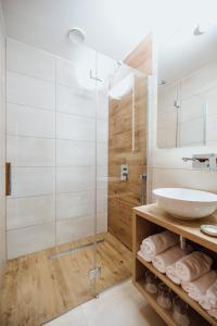 a bathroom with a glass shower and a sink at Gostišče Iršič in Slovenska Bistrica