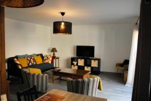 a living room with a couch and a table at La maison du fond in Honfleur
