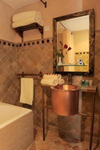 a bathroom with a copper sink and a mirror at Art suites in El Jadida