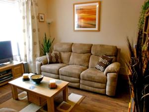 a living room with a couch and a coffee table at Eden's Rest Bed and Breakfast in St Austell