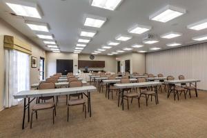 a classroom with tables and chairs in a room at Sleep Inn & Suites in Miles City