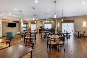 a restaurant with tables and chairs in a room at Sleep Inn & Suites Miles City in Miles City